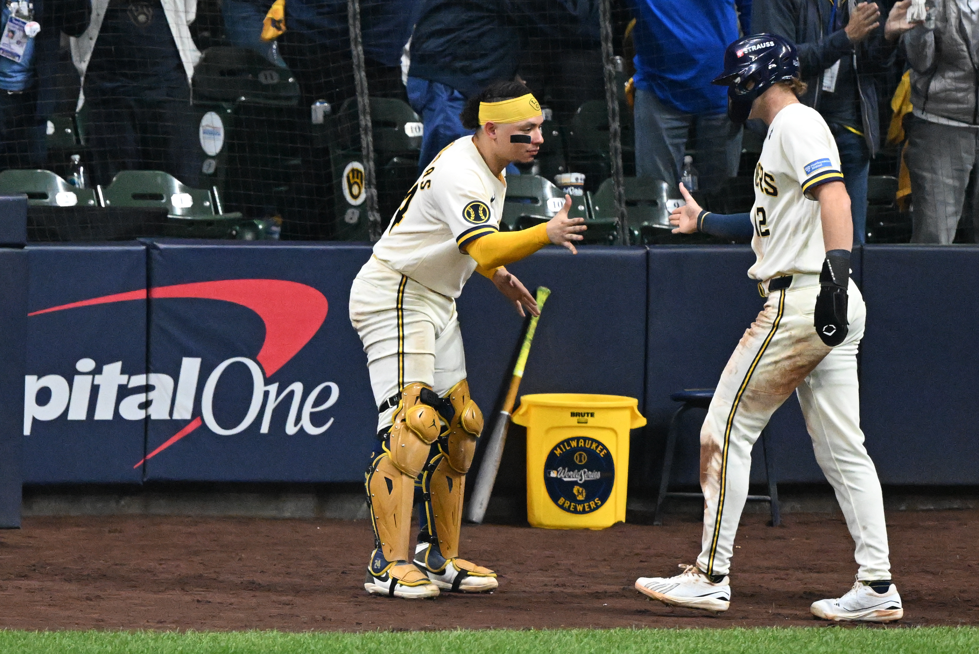 Milwaukee Brewers infielder Cooper Pratt (12) celebrates with catcher William Contreras (24) after scoring on a fielding error by Tampa Bay Rays infielder Jonathan Aranda (not pictured) during the fourth inning in game two of the 2026 World Series at American Family Field.